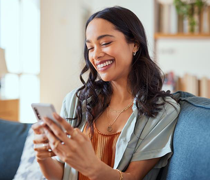 Woman smiling at her phone